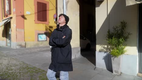 man standing in city street