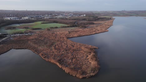 top-down view, land tongue in lake - tilt up shot and dolly out shot