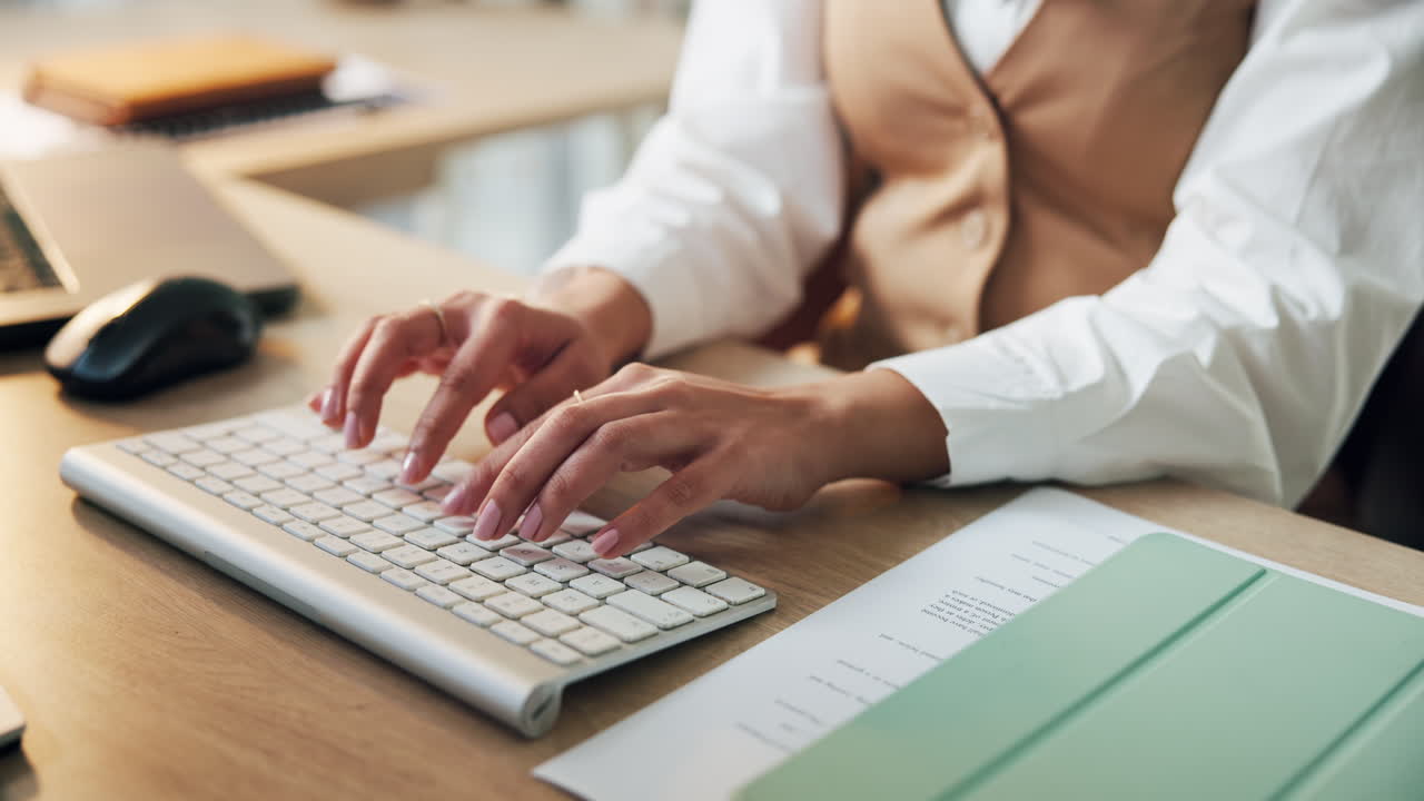 Woman typing on a keyboard at her desk