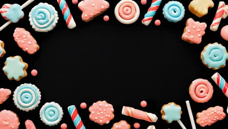 colorful candy and cookie frame on black background
