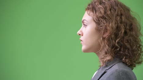 closeup profile view of young beautiful businesswoman with curly hair