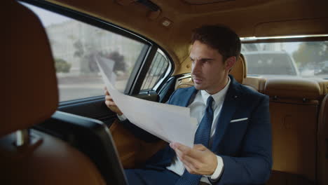 angry business man frustrating with poor results in modern car. stressed guy