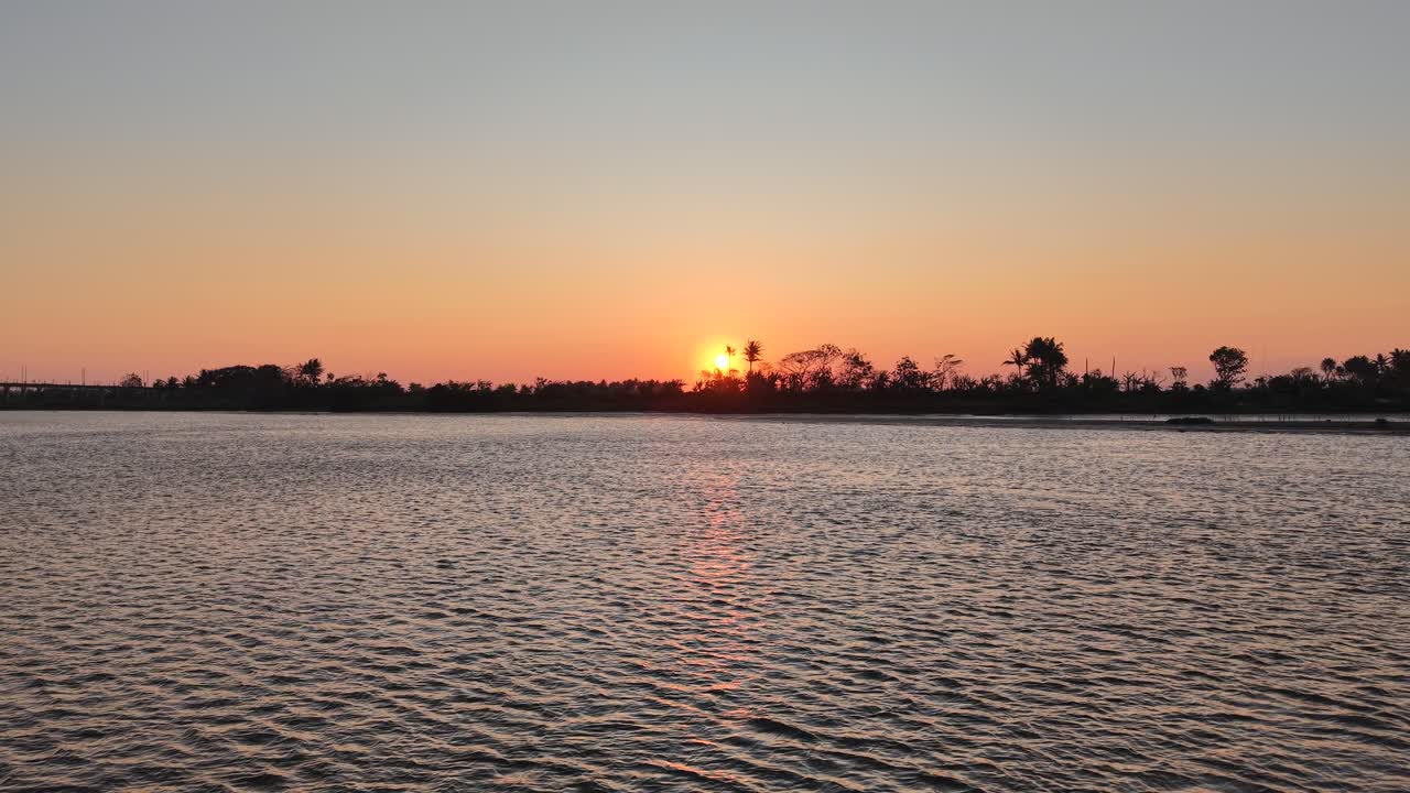 A beautiful sunset silhouetted against a swamp, river, and trees. This video is perfect for an intro or opening