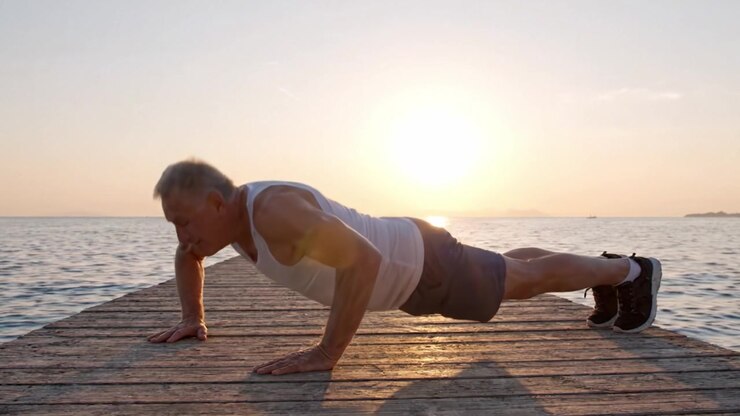 An Inspirational Scene of an Older Man Performing Push-Ups on a Pier with a Beautiful Sunset, Showcasing Fitness and Resilience Against Nature's Splendor