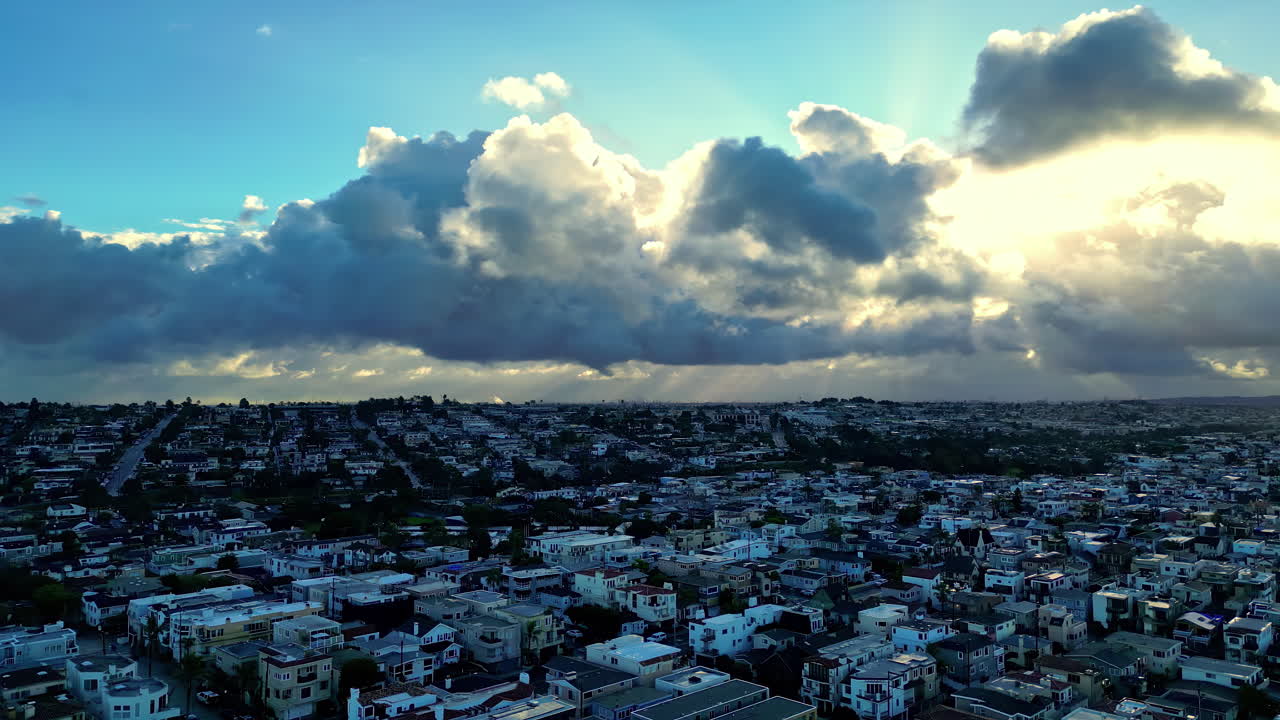 Aerial view of dense Los Angeles neighborhoods with dramatic clouds after rain