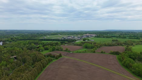 new housing development in alton, caledon region, ontario, canada with lush open landscape, aerial establishing