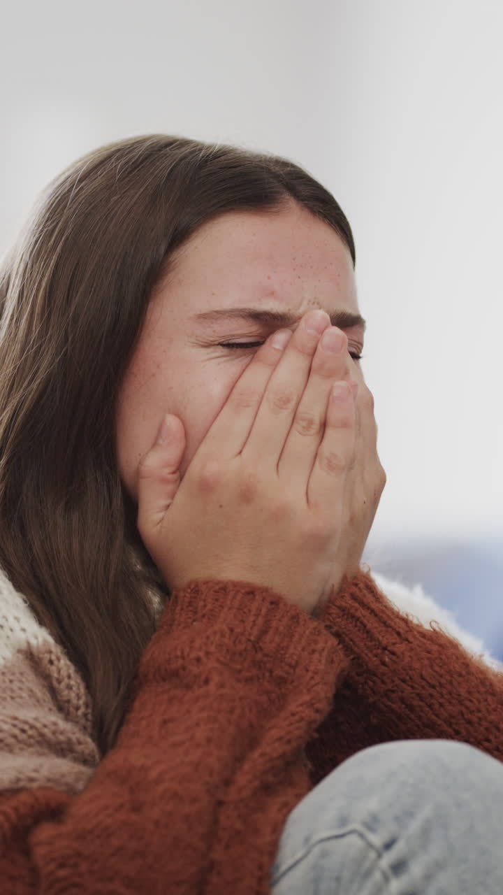Vertical video of sad caucasian teenage girl crying in slow motion
