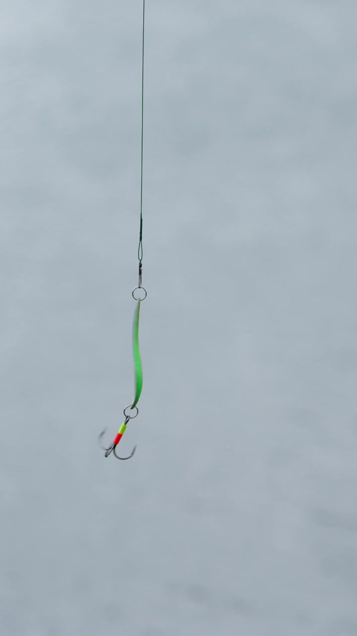 Close-up of a Fishing Lure with Treble Hook Swinging
