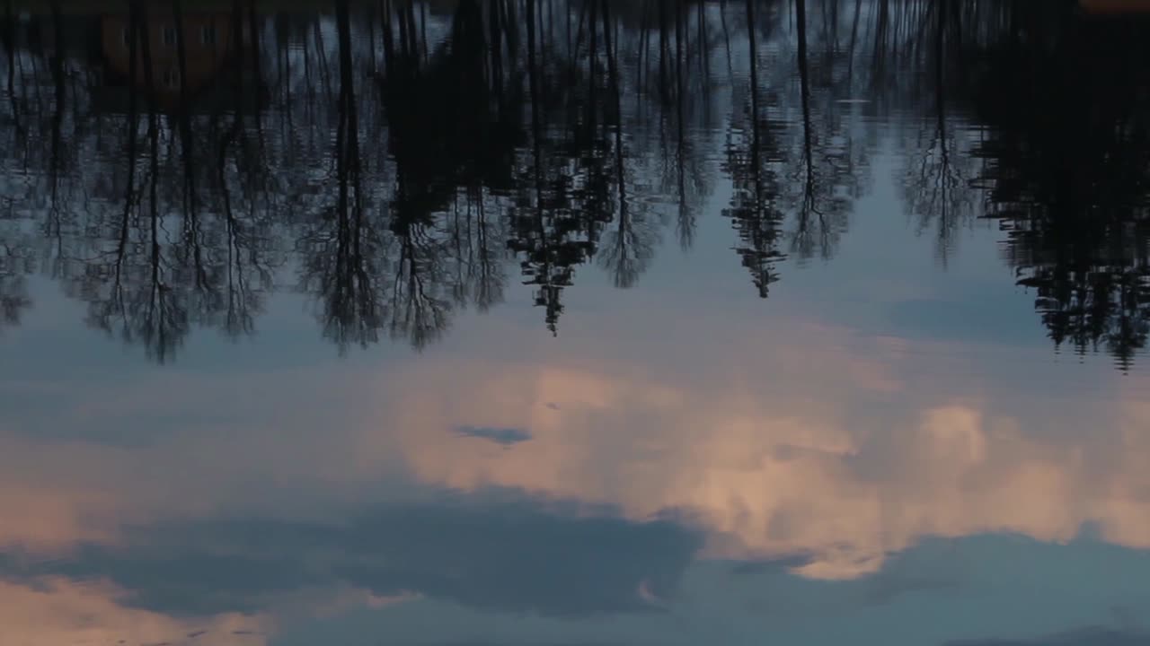Sunset Clouds Reflected in River Water. Time Lapse