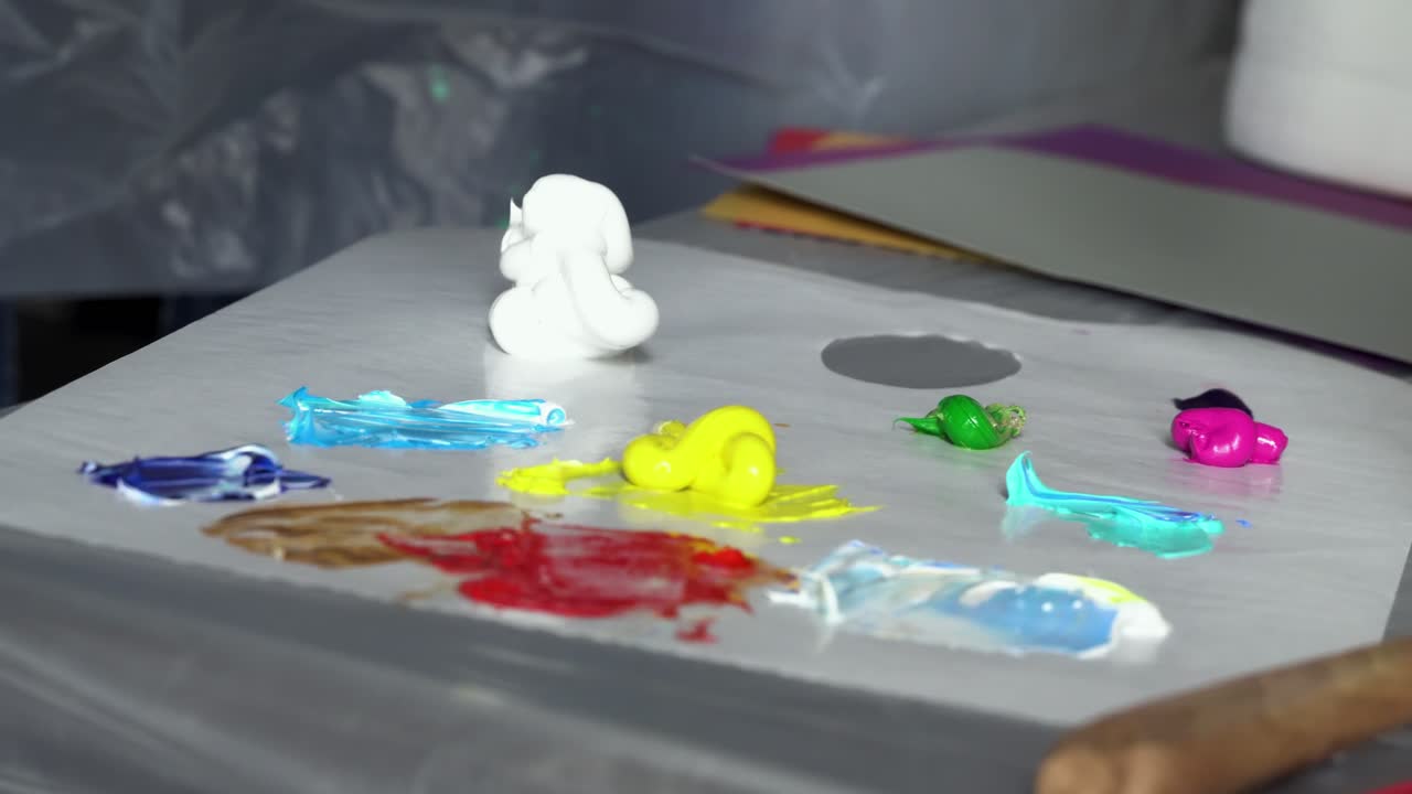 artista mezclando pinturas en una paleta