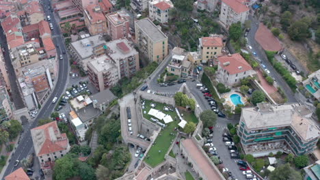 Wedding-venue-reception-on-top-of-historical-Italian-town,-green-garden,-aerial