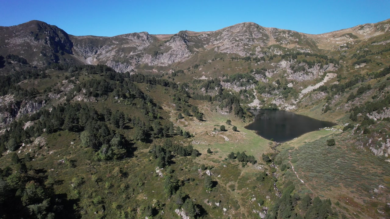 Aerial views of an alpine lake in the french Pyrenees at low altitude