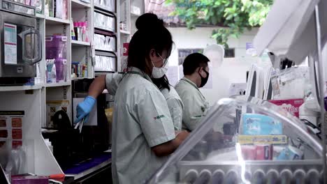 Shot Of Seven Eleven Cashiers Wearing Facial Mask Due To Coronavirus Outbreak, Bangkok Thailand
