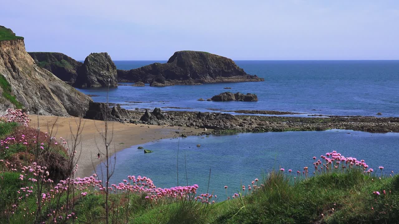 person walking on idillic beach vibrant colours copper Coast Waterford Ireland Epic Locations