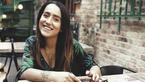 Woman-with-a-tattoo-sitting-eating-outdoors