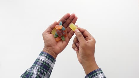 hand holding colorful gummy candies