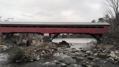 aerial pullback revealing the taftsville bridge over the ottauquechee river