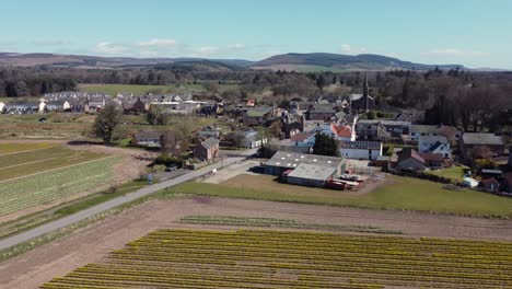 Aerial-view-of-the-Scottish-town-of-Fettercairn-on-a-sunny-spring-day,-Aberdeenshire,-Scotland