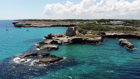 drone revealing roca vecchia tower and landscape with a slow camera rotation during a sunny summer day