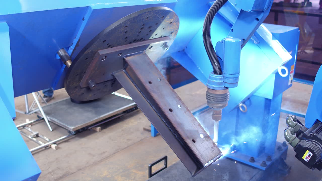Close Up Of A Robotic Welder At Work. Robotic Arm With Torch Welding Metal.