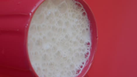 close-up of frothy liquid in a red cup