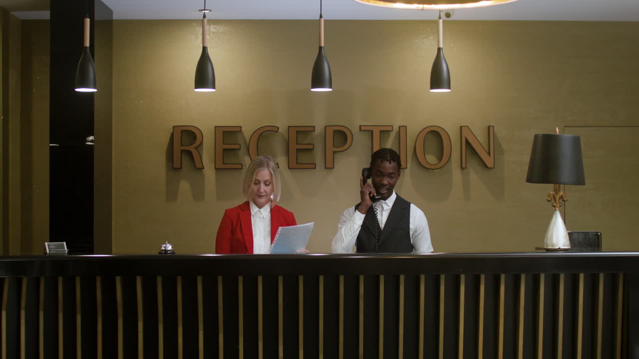 Hotel receptionists working in the hotel hall