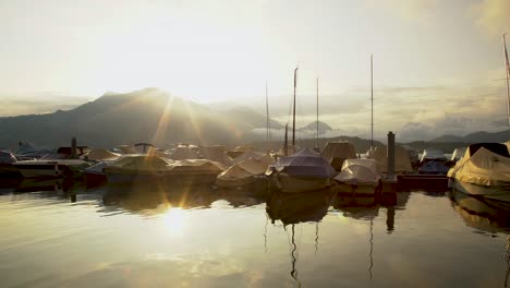 golden sunrise reflection on lucerne lake waterfront and harbor, switzerland