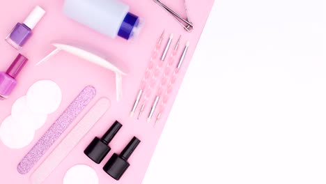 tools for manicure and nail polishes appear on pink side on pink white theme. stop motion