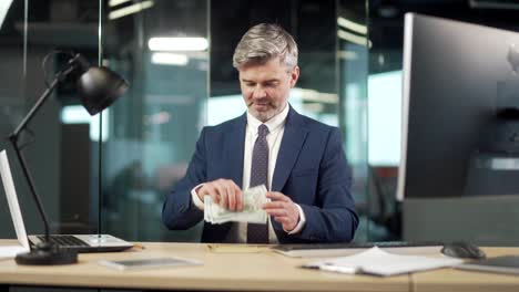 business employee man in office counts the cash money in an envelope, clerk corrupt received a bribe. illegal unethical gift or lobbying