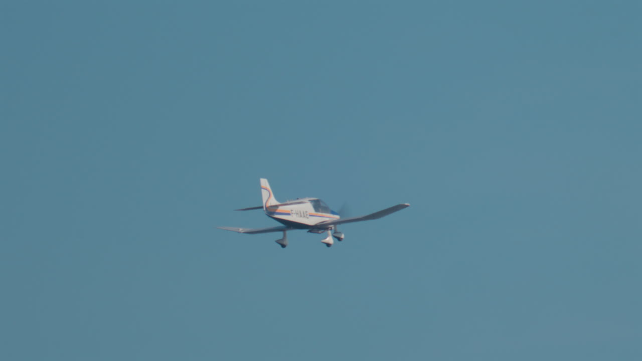 Cannes, France - October 10, 2025: A small single engine aircraft glides smoothly across a bright blue sky near the French Riviera