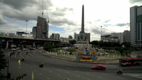 watching the cars at the victory monument in bangkok