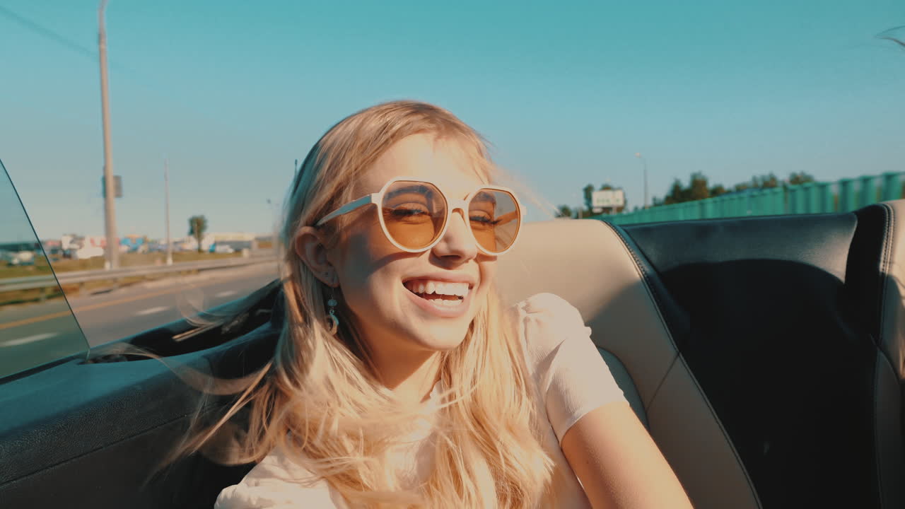 mujer feliz conduciendo un descapotable en un día soleado