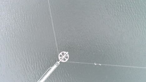 aerial close up drone shot of pulling system of a waterpark for wakeboarding and waterskiing