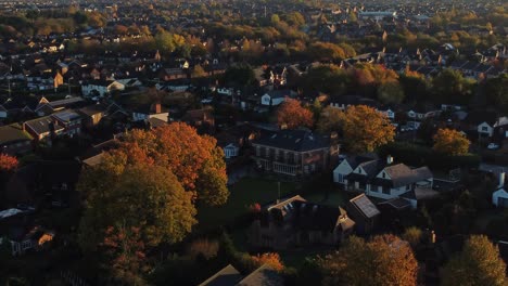 british neighbourhood housing aerial view looking down over early morning sunrise autumn coloured townhouse rooftops