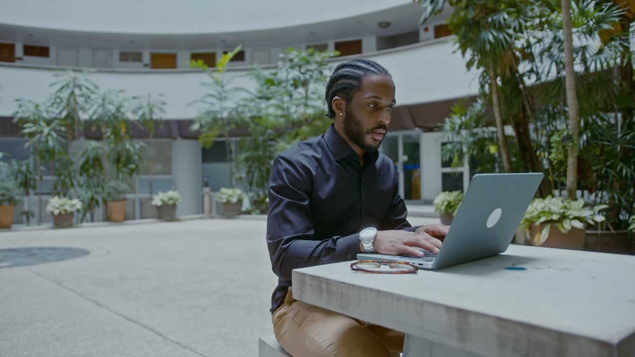 Man Working on Laptop Outdoors