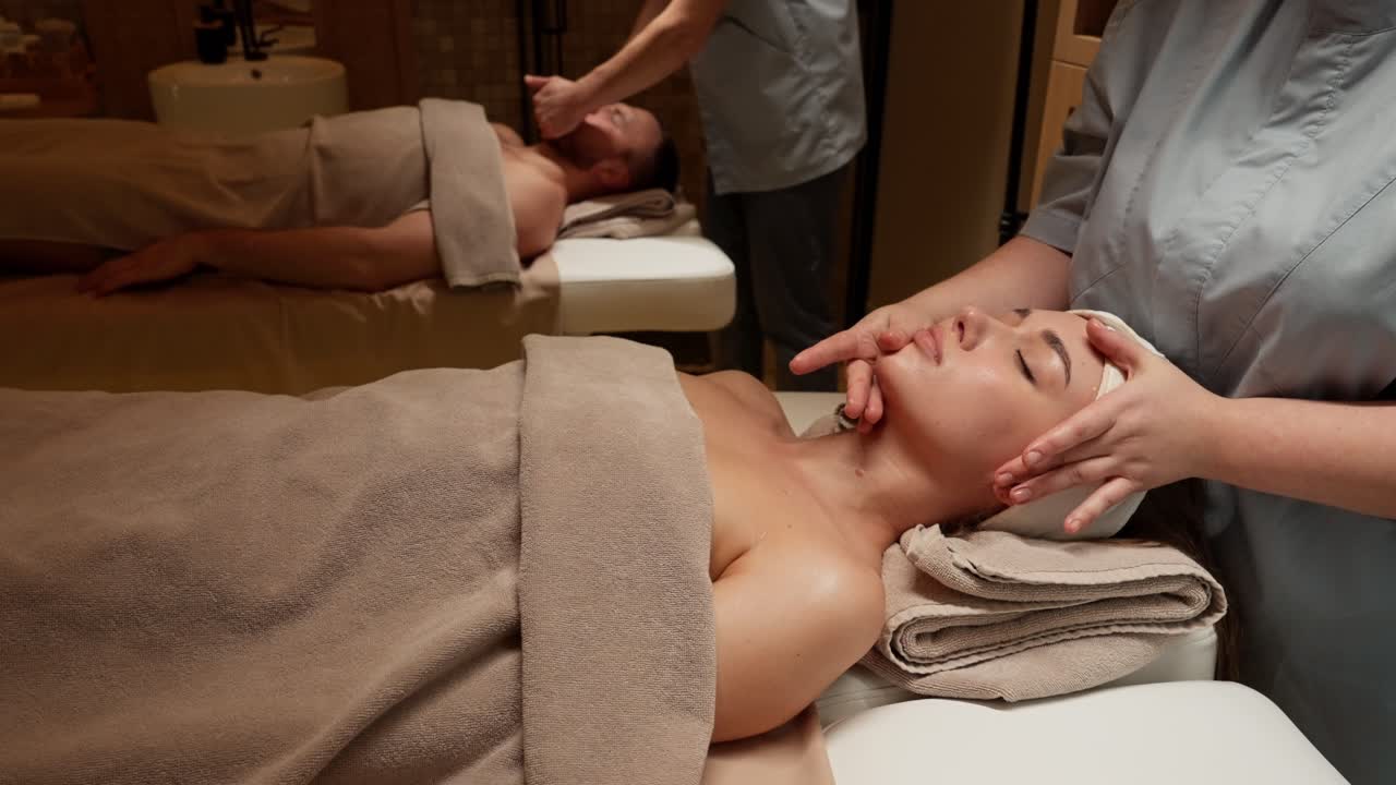Couple Receiving Relaxing Facial Massages in a Luxury Spa