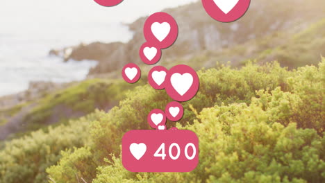 animation of social media heart icons and shore with sea landscape