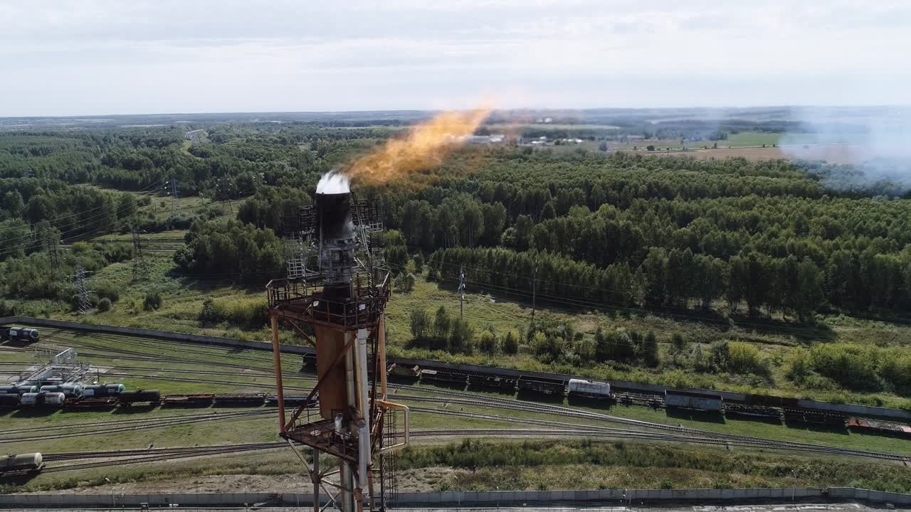 A tower for flaring associated gas at a petrochemical plant. Fiery torch