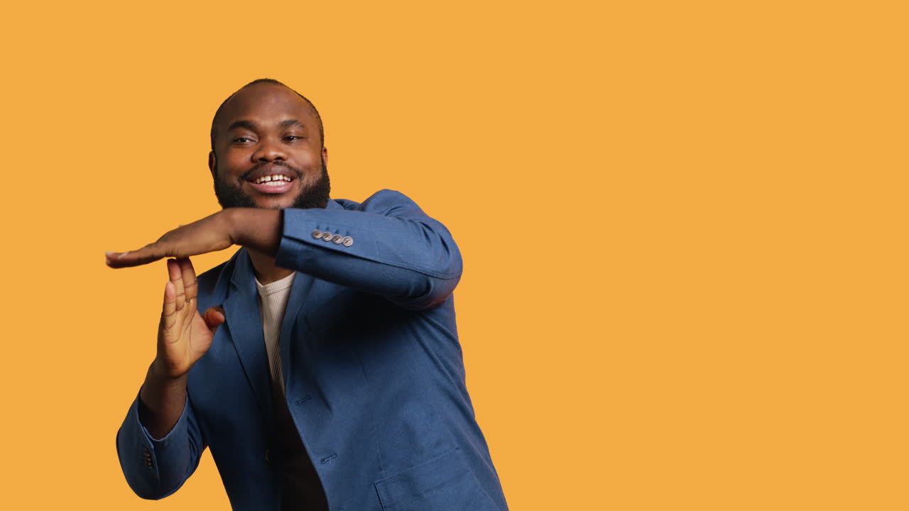 Cheerful man asking for timeout, halting activities, studio background