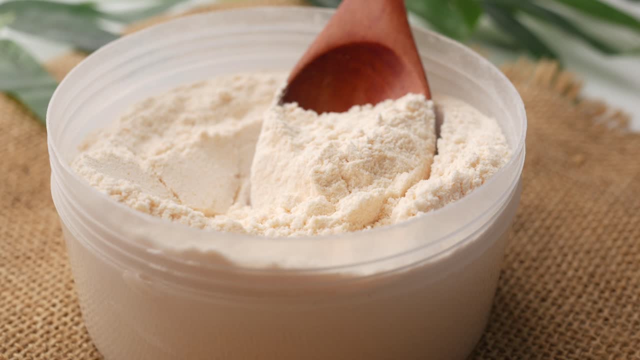 Powder in a container with a wooden spoon