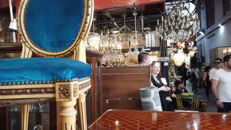 people walk inside vintage flea market with antique furniture of buenos aires city, palermo, mercado de pulgas