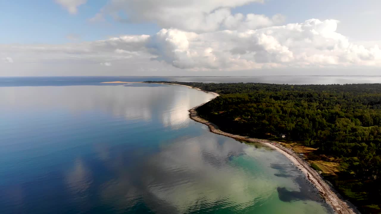 Aerial View of a Beautiful Coastline with Calm Ocean and Lush Green Island