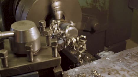 industrial lathe (milling machine) shaping thick metal workpiece. metallic scrap flying away
