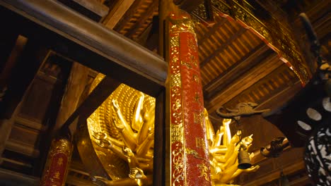 a beautiful ornate buddha statue inside the temple complex at bai dinh pagoda in ninh binh province, vietnam