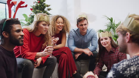 group of friends playing charades after enjoying christmas dinner at home