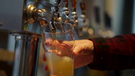 pouring a glass of beer at a micro brewery