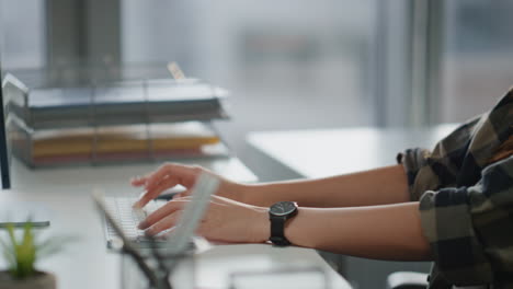 Focused-woman-hands-typing-keyboard-office-closeup.-Involved-man-working-laptop