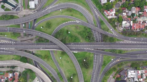 aerial top down view of a highway interchange with a few cars during coronavirus pandemic