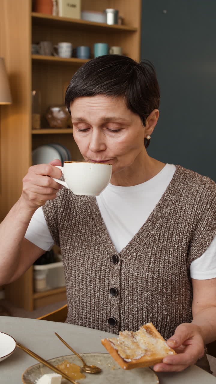 Woman Enjoying Breakfast with Toast and Coffee at Home