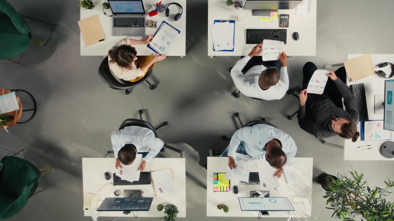 Vertical Video Top down view zoom in of employees collaborating on planning business strategy